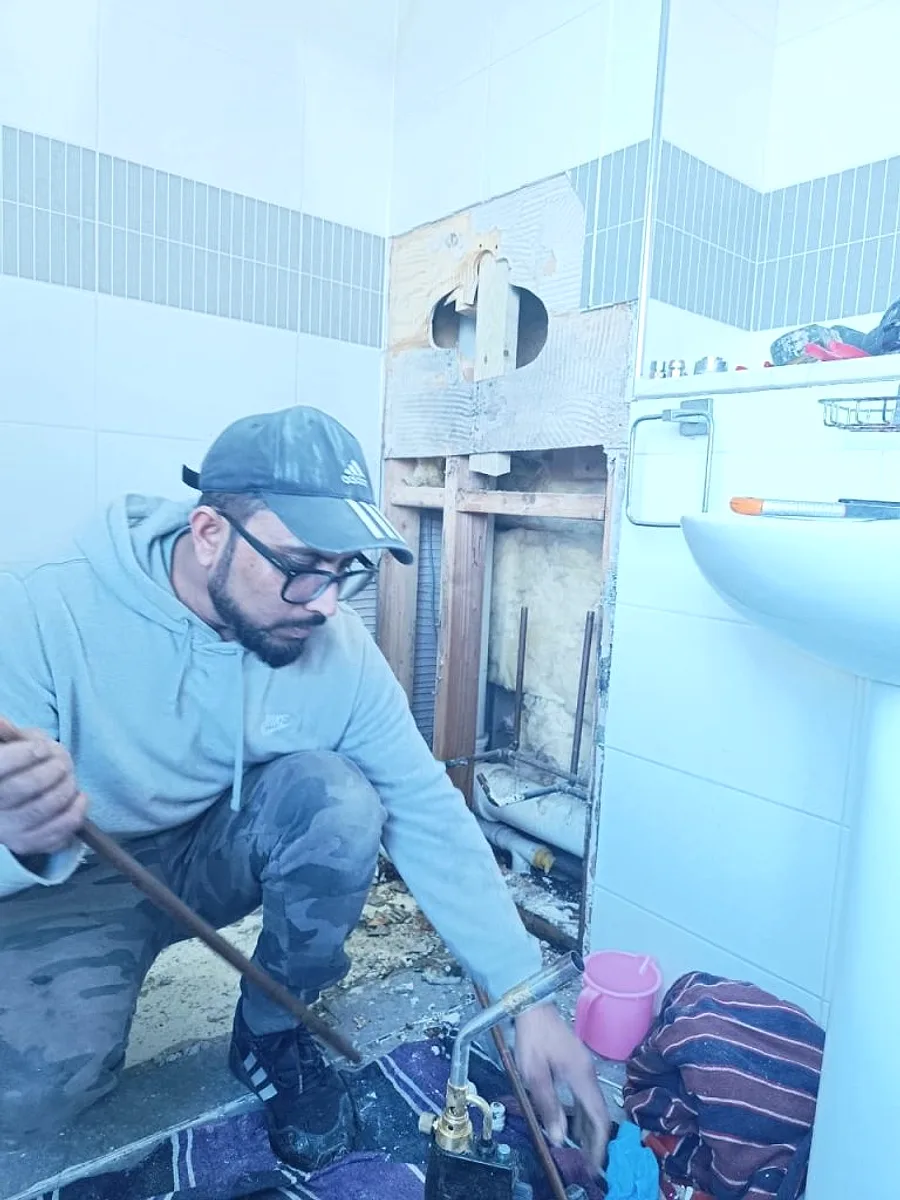 A Yamin Heating & Plumbing engineer carrying out pipework on a job in Leicester